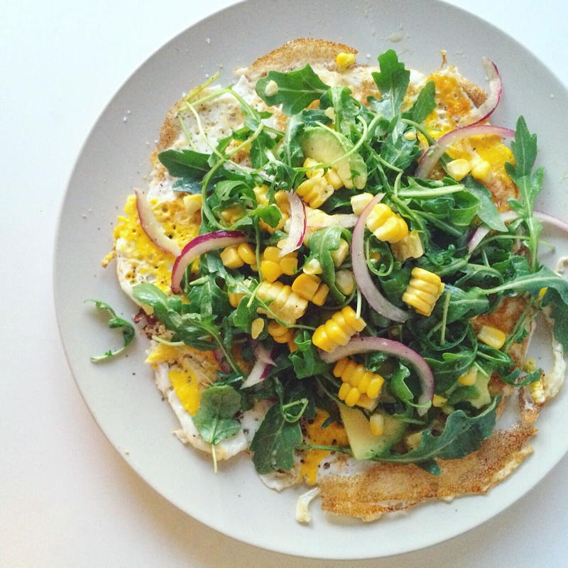 open faced omelette  with arugula sweet corn and avocado 