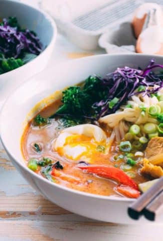 a satisfying and easy curry noodle soup made with chicken, udon noodles, red curry paste, garlic, ginger, turmeric, onions, red peppers, broccolini, soft boiled eggs and finished with cilantro, green onions and shredded red cabbage. super delicious and could be easily adapted to vegetarian or gluten free! | www.nyssaskitchen.com
