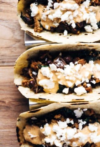 a quick and healthy recipe for chicken tacos with black beans, kale, romesco yogurt sauce and feta cheese. | www.nyssaskitchen.com