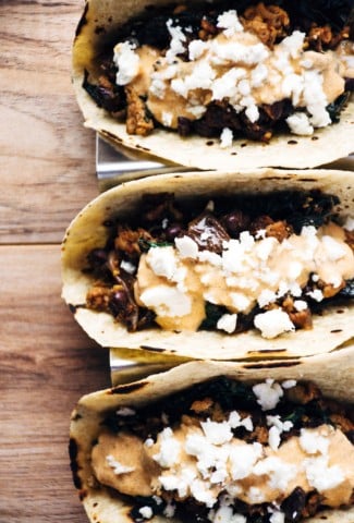 a quick and healthy recipe for chicken tacos with black beans, kale, romesco yogurt sauce and feta cheese. | www.nyssaskitchen.com