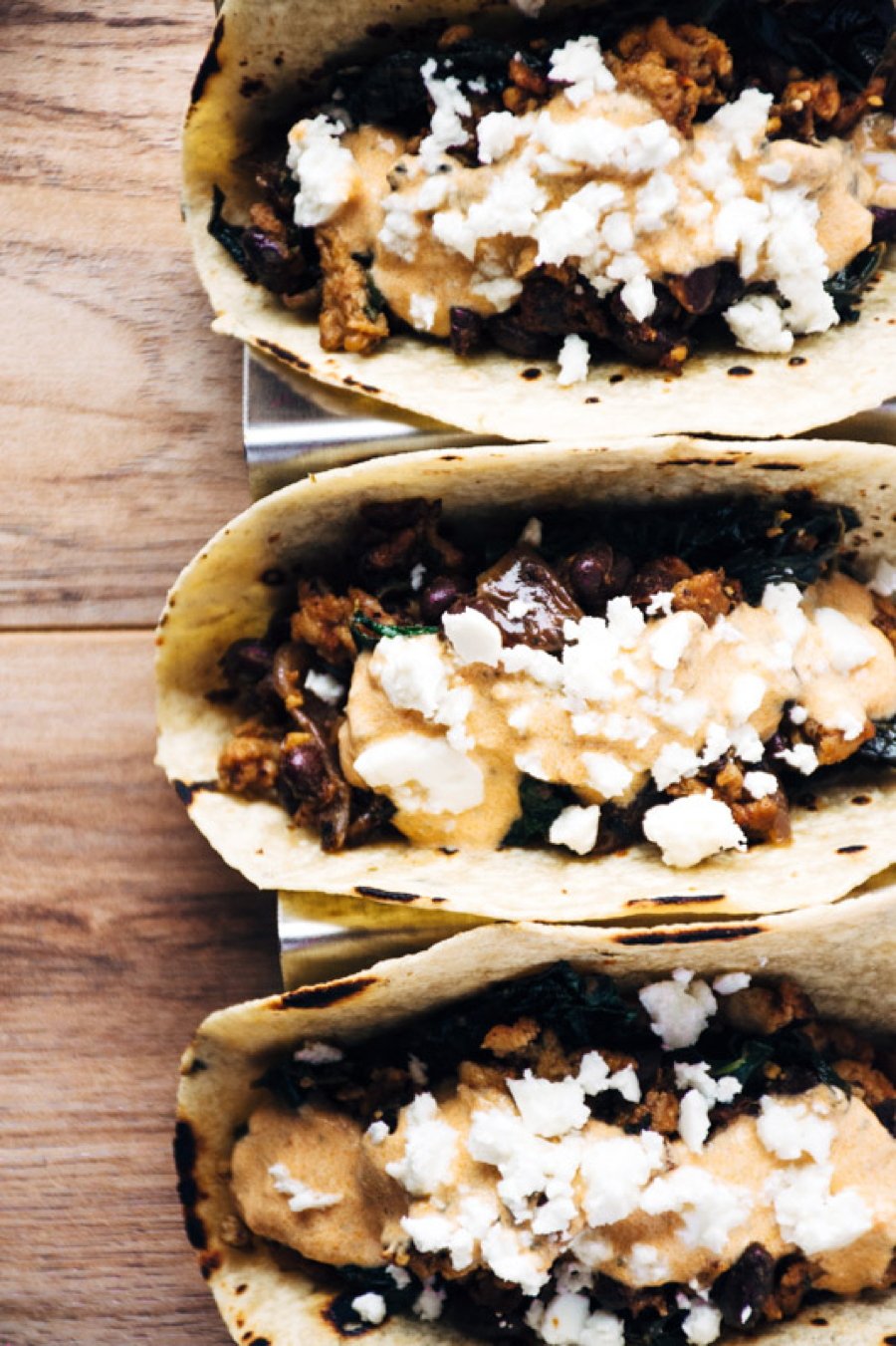 a quick and healthy recipe for chicken tacos with black beans, kale, romesco yogurt sauce and feta cheese. | www.nyssaskitchen.com