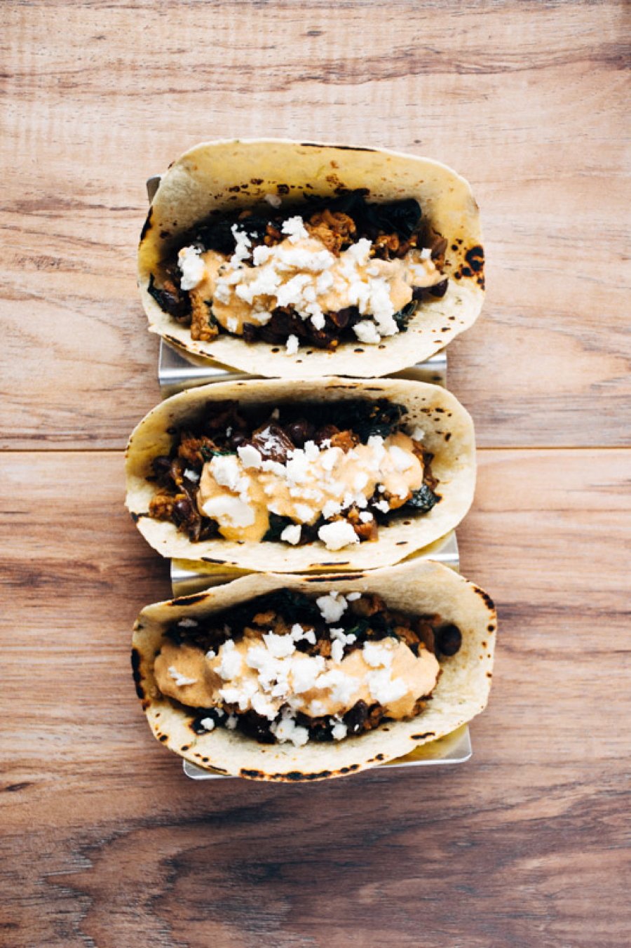 a quick and healthy recipe for chicken tacos with black beans, kale, romesco yogurt sauce and feta cheese. | www.nyssaskitchen.com