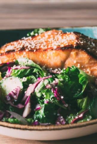 a mega healthy and flavorful recipe for garlicky miso marinated salmon with a big salad of fresh romaine and arugula, cucumbers, red cabbage and a lime and olive oil vinaigrette | www.nyssaskitchen.com