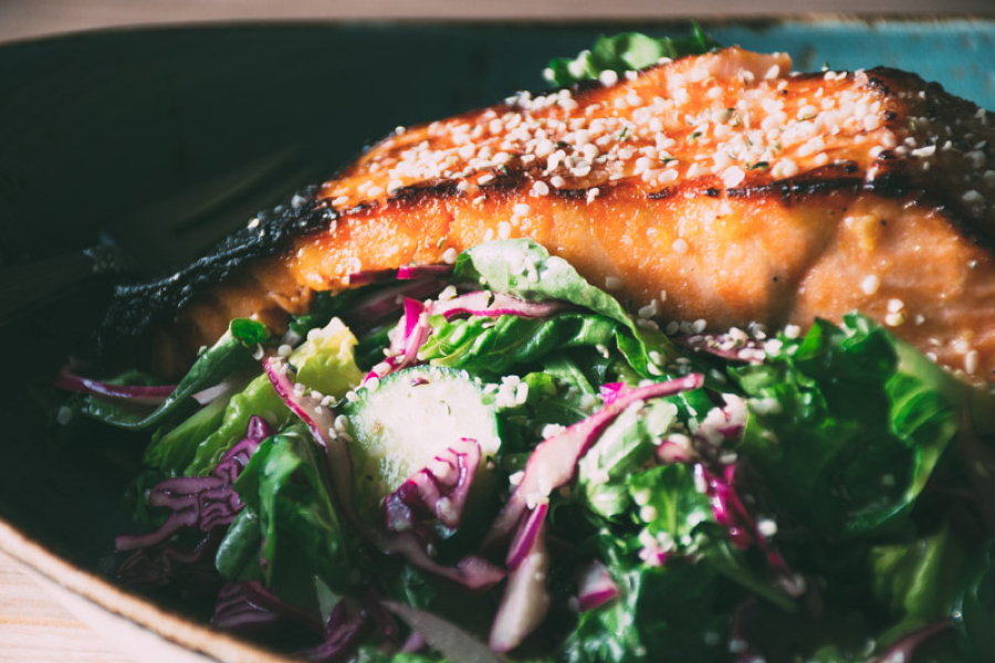 a mega healthy and flavorful recipe for garlicky miso marinated salmon with a big salad of fresh romaine and arugula, cucumbers, red cabbage and a lime and olive oil vinaigrette | www.nyssaskitchen.com