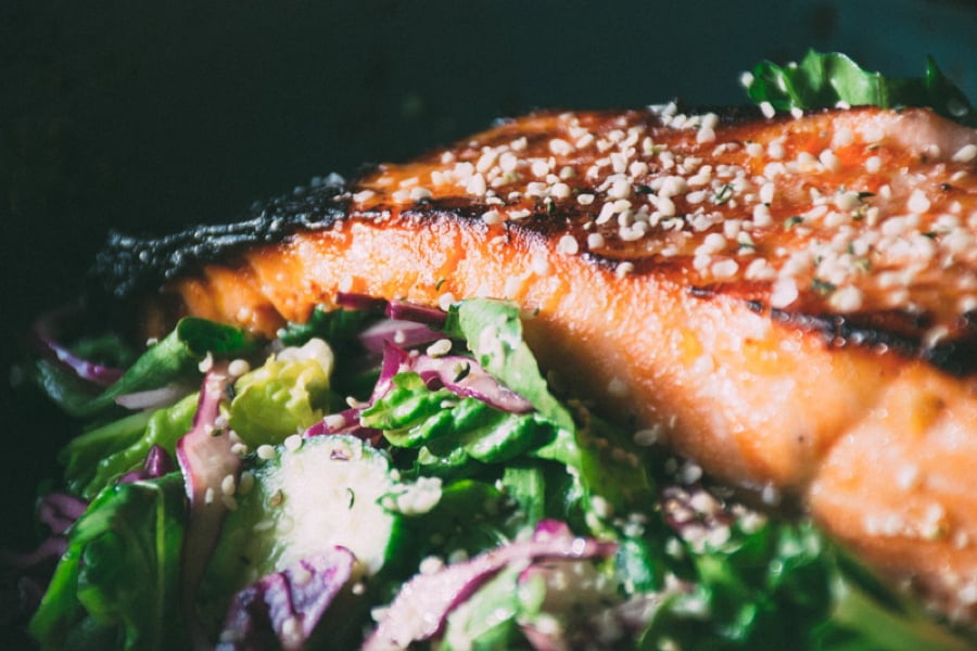 a mega healthy and flavorful recipe for garlicky miso marinated salmon with a big salad of fresh romaine and arugula, cucumbers, red cabbage and a lime and olive oil vinaigrette | www.nyssaskitchen.com