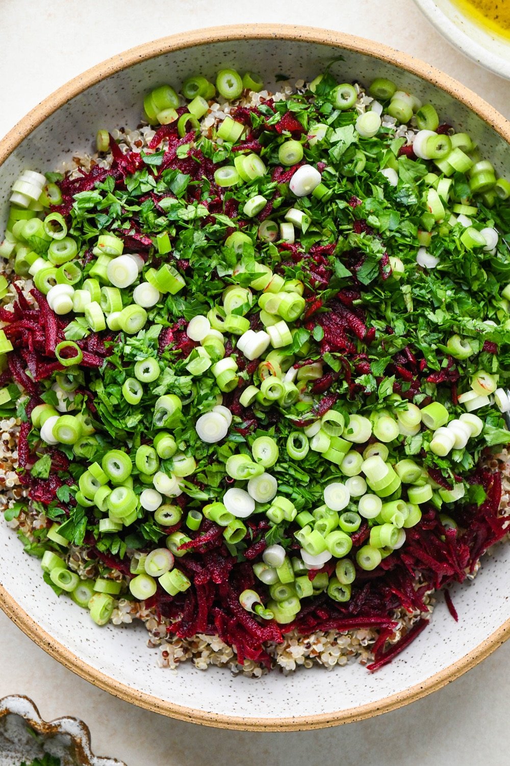 How to make quinoa and fresh beet salad: All ingredients for quinoa salad in a large bowl before mixing together.