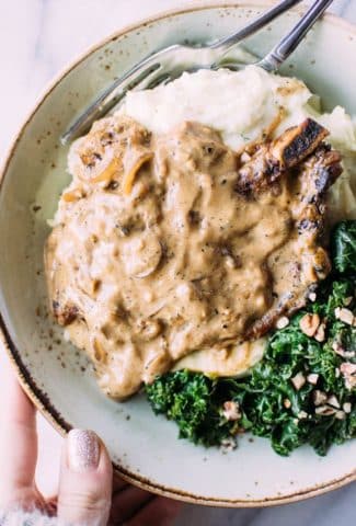 caramelized-onion-smothered-pork-chops-with-herb-whipped-parsnips-and-kale