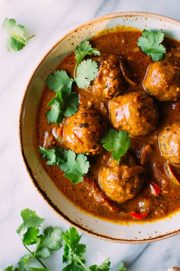 Best ever paleo curried pork meatballs! The most delicious grain free meatballs I've ever had. Perfectly spiced, sturdy yet tender, and paired with an incredibly flavorful curry sauce with red peppers, tomatoes, onion, garlic and ginger. 
