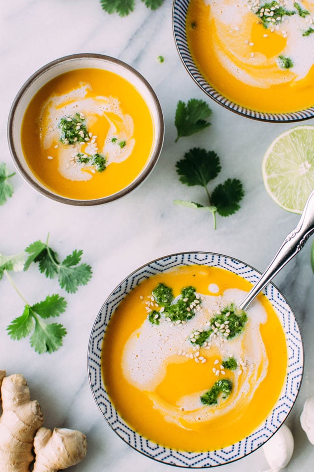 Thai carrot and sweet pepper coconut soup with cilantro pesto - The perfect, vibrant, veggie packed soup for your midwinter cravings! It's loaded with carrots, sweet peppers, onion, garlic, lemongrass, lime leaves and spices, blended with some creamy coconut milk and topped with a fresh and flavorful cilantro pesto.