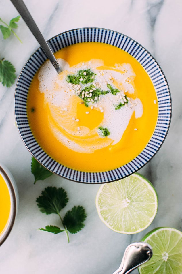 Thai carrot and sweet pepper coconut soup with cilantro pesto - The perfect, vibrant, veggie packed soup for your midwinter cravings! It's loaded with carrots, sweet peppers, onion, garlic, lemongrass, lime leaves and spices, blended with some creamy coconut milk and topped with a fresh and flavorful cilantro pesto.