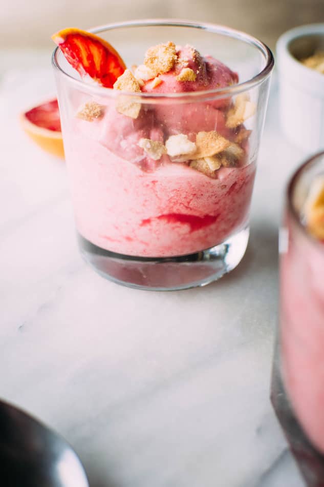 Three ingredient blood orange mousse with coconut crumble! The crazy easy answer to your sweet tooth cravings. All it takes is frozen blood oranges, an egg white, a little bit of a natural sweetener and your trusty food processor to have this treat on the table in no time!