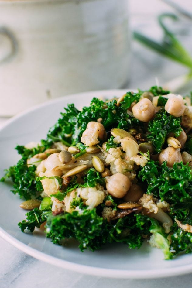 chopped winter detox salad with roasted cauliflower + chickpeas + kale! Gluten free, vegan and easily made paleo by substituting the chickpeas for some chicken or turkey, this hearty and healthy winter salad is the perfect clean salad to tuck into your fridge and enjoy all week long!