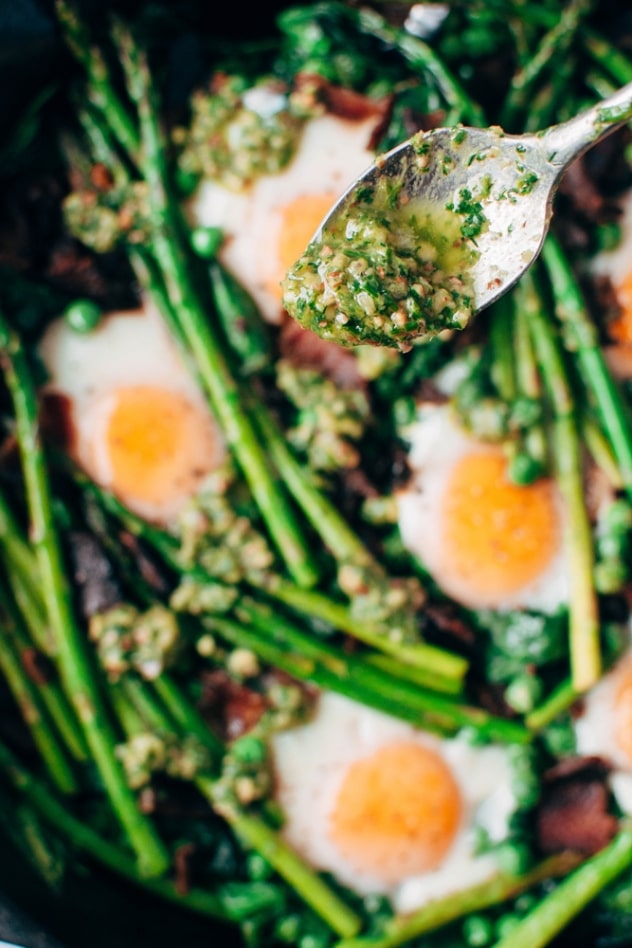 Easy spring veggie egg skillet with bacon and herbed almond pesto made with asparagus, peas, baby spinach, bacon and pastured eggs is the perfect spring brunch dish for you and yours!