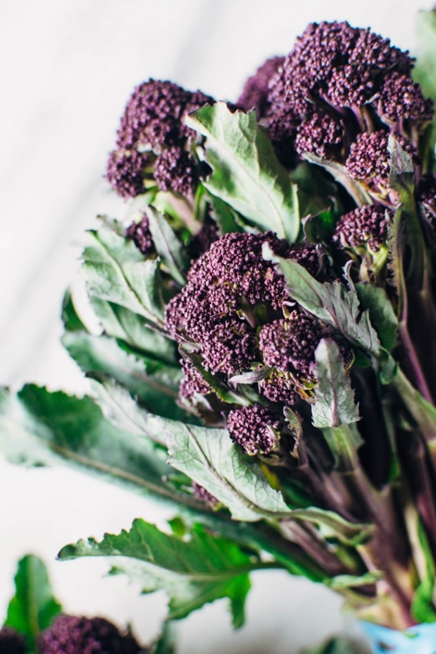 Charred purple sprouting broccoli with caper basil tahini sauce is a simple spring vegetable recipe with purple sprouting broccoli and an easy to make tahini sauce that's elevated with garlic, lemon, capers and basil, topped with some toasted sunflower seeds for crunch.