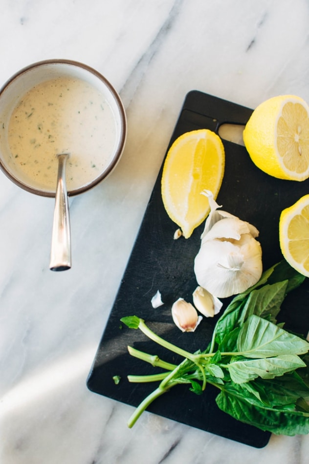 Charred purple sprouting broccoli with caper basil tahini sauce is a simple spring vegetable recipe with purple sprouting broccoli and an easy to make tahini sauce that's elevated with garlic, lemon, capers and basil, topped with some toasted sunflower seeds for crunch.