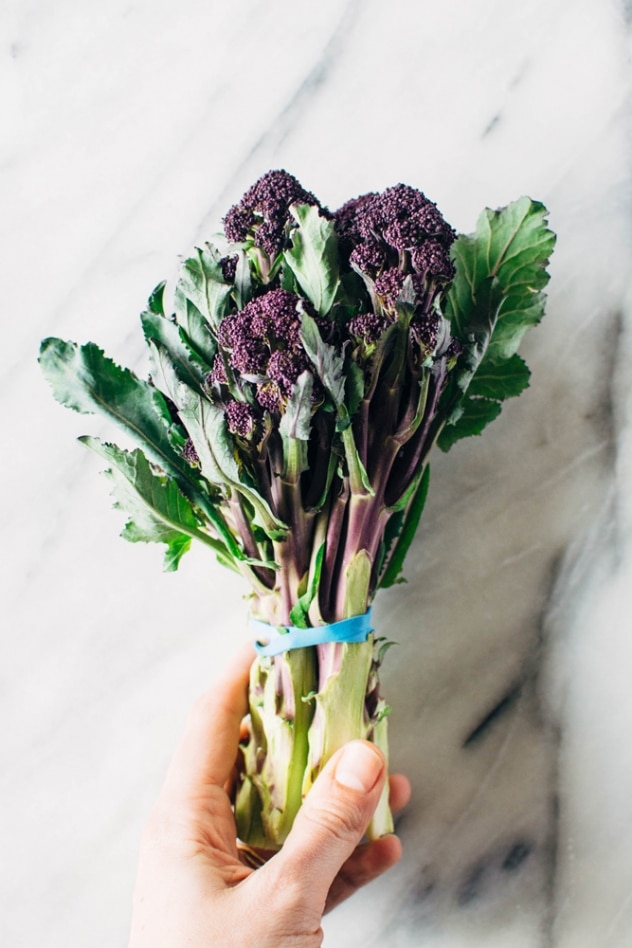 Charred purple sprouting broccoli with caper basil tahini sauce is a simple spring vegetable recipe with purple sprouting broccoli and an easy to make tahini sauce that's elevated with garlic, lemon, capers and basil, topped with some toasted sunflower seeds for crunch.