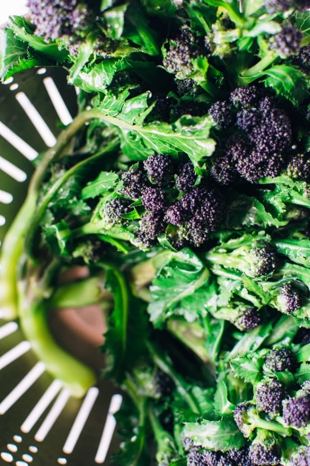 Charred purple sprouting broccoli with caper basil tahini sauce is a simple spring vegetable recipe with purple sprouting broccoli and an easy to make tahini sauce that's elevated with garlic, lemon, capers and basil, topped with some toasted sunflower seeds for crunch.