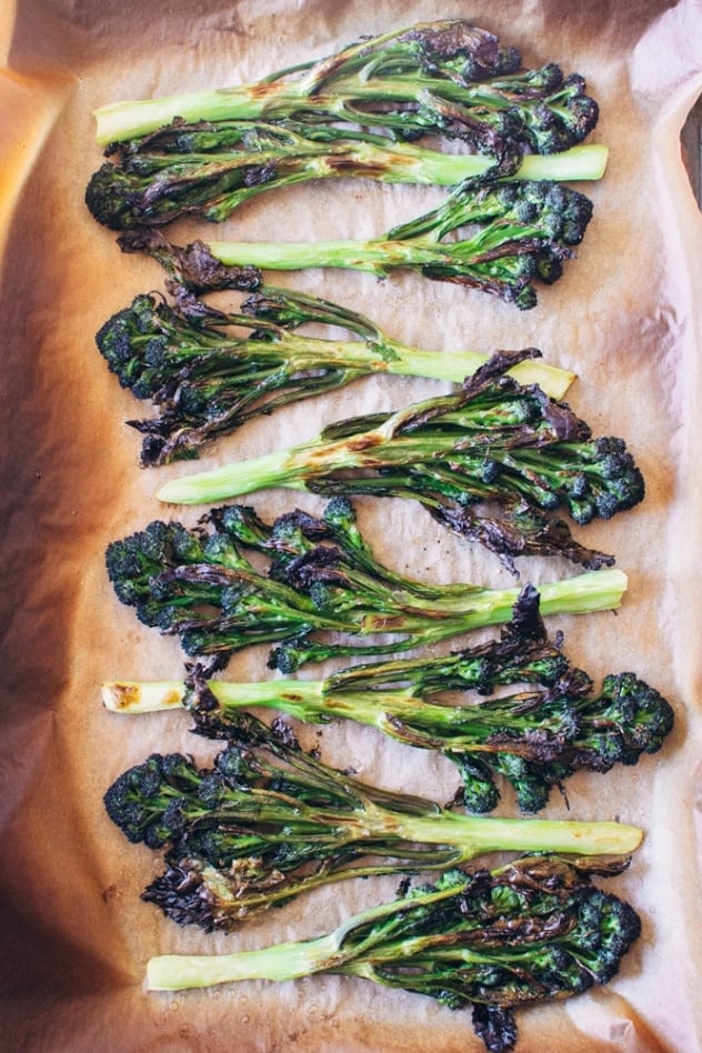 Charred purple sprouting broccoli with caper basil tahini sauce is a simple spring vegetable recipe with purple sprouting broccoli and an easy to make tahini sauce that's elevated with garlic, lemon, capers and basil, topped with some toasted sunflower seeds for crunch.