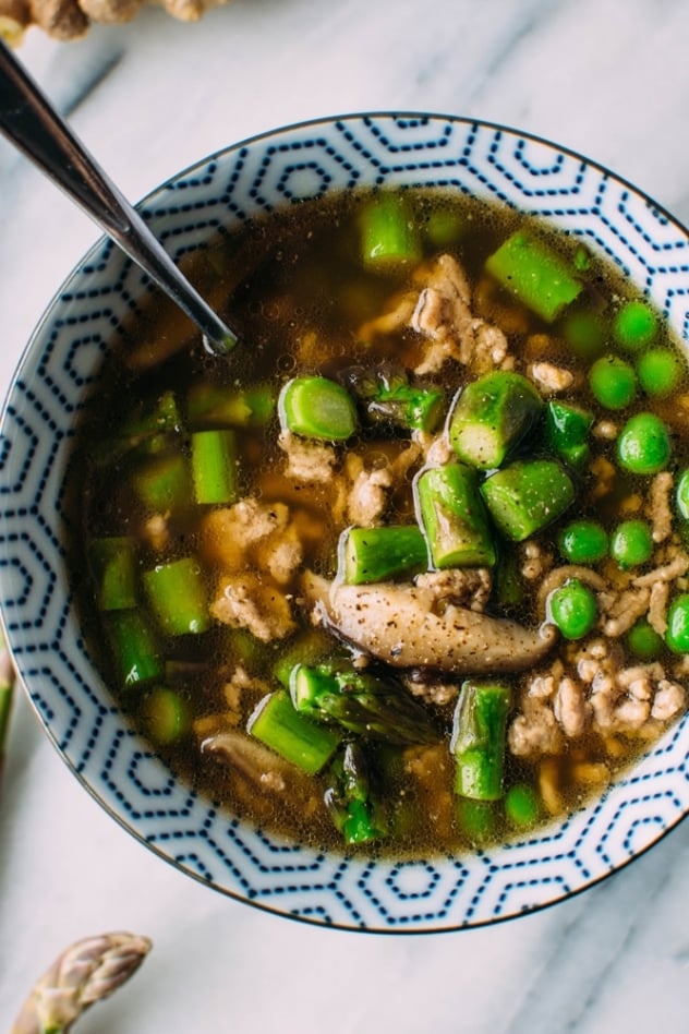 Gingered pork soup with green spring vegetables and szechuan broth made with asparagus, peas and shiitake mushrooms - it's an umami rich bowl of goodness and the perfect way to warm up AND indulge in some of the new spring vegetables that are making their way into our markets.