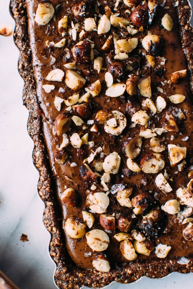 Salted mocha hazelnut tart with Rawmio chocolate is an incredibly decadent and satisfying vegan and paleo dessert! No bake, made with nutrient dense ingredients, and sprinkled with sea salt like every great chocolate dessert should be.