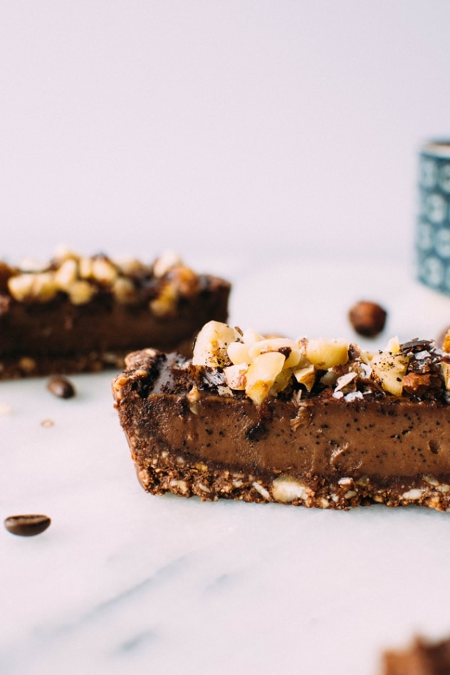 Salted mocha hazelnut tart with Rawmio chocolate is an incredibly decadent and satisfying vegan and paleo dessert! No bake, made with nutrient dense ingredients, and sprinkled with sea salt like every great chocolate dessert should be.