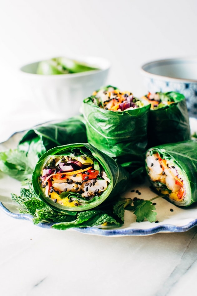 Rainbow collard green spring rolls with shrimp! Layers of tangled crunchy veggies, perfectly pan seared shrimp, spicy mayo, all tucked inside some SUPER HEALTHY collard green wraps! 