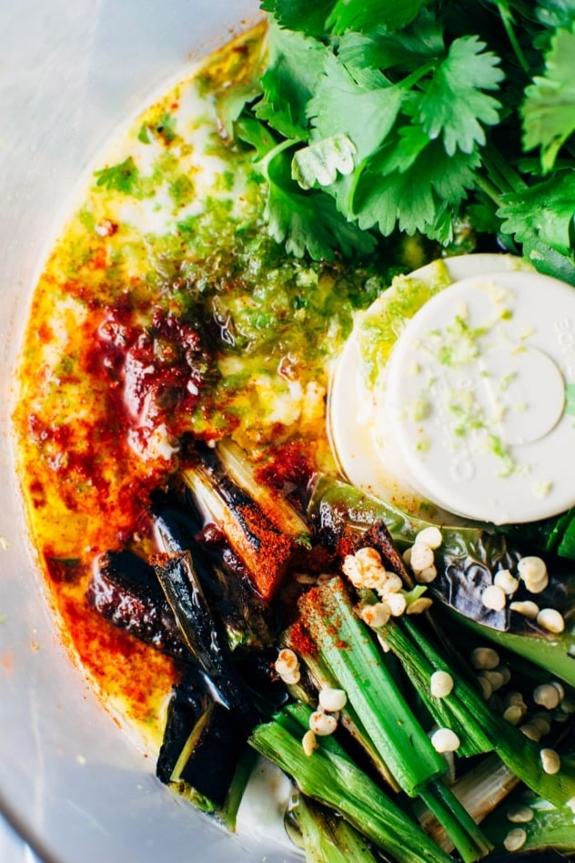 Green sauce ingredients for mango chorizo taco salad bowls! Spicy crumbled chorizo layered over salad greens with a rainbow of veggies and all your favorite toppings.