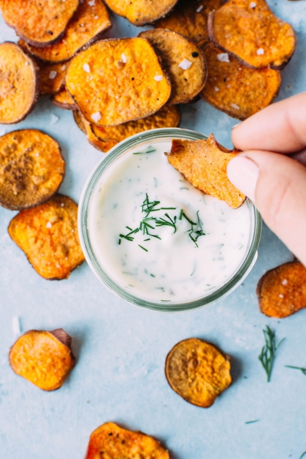 Healthy oven baked sweet potato chips with dairy free ranch dressing! A salty, crunchy and satisfying make at home snack that's loaded with anti-oxidants and healthy fats. 