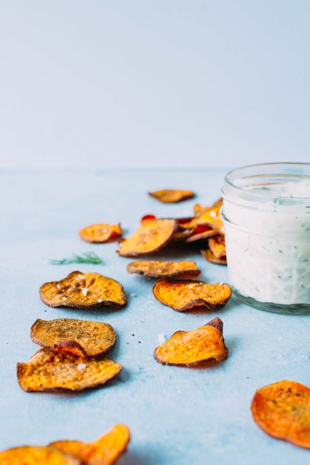 Healthy oven baked sweet potato chips with dairy free ranch dressing! A salty, crunchy and satisfying make at home snack that's loaded with anti-oxidants and healthy fats. 