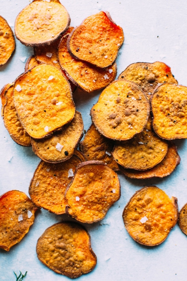 Healthy oven baked sweet potato chips with dairy free ranch dressing! A salty, crunchy and satisfying make at home snack that's loaded with anti-oxidants and healthy fats. 