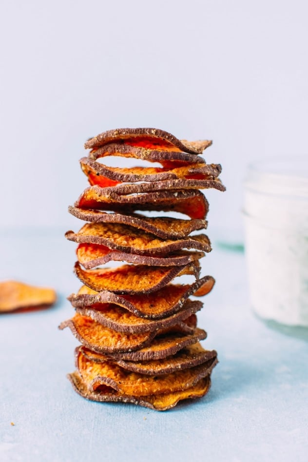 Healthy oven baked sweet potato chips with dairy free ranch dressing! A salty, crunchy and satisfying make at home snack that's loaded with anti-oxidants and healthy fats. 