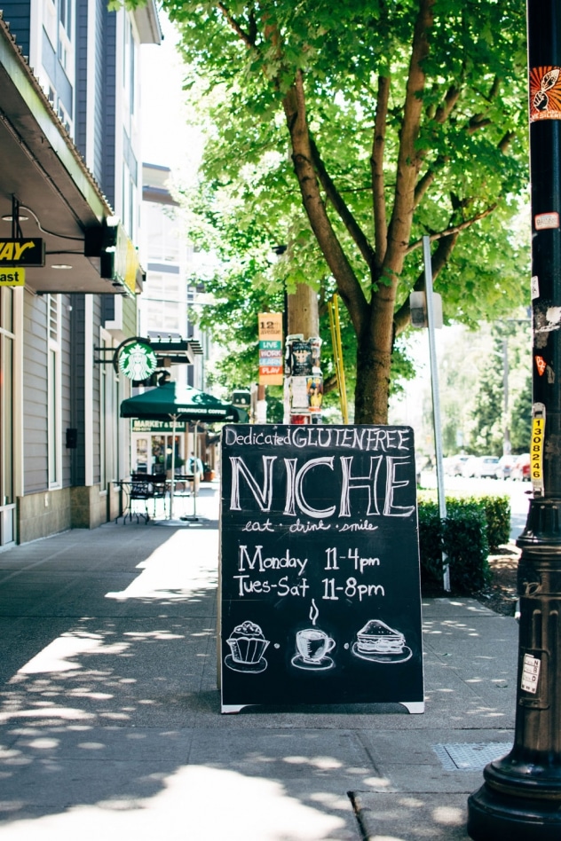Niche - a gluten free bakery and cafe in Seattle, WA! Get ready to be tempted by some seriously mouth-watering treats as you browse their main menu since the ordering counter is lined with whatever sweet treats are fresh baked for the day - you may even be able to watch them frosting some cupcakes or pulling cookies out of the oven, as their workspace is directly behind it. Their non-bakery items menu consist mostly of various types of sandwiches, bowls, salads, and WAFFLES and waffle-inis!