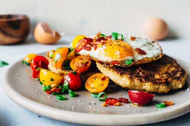 A crazy easy and delicious recipe for savory breakfast pancakes! Made with crumbled bacon, green onions, and topped with a tomato jalapeño salad and fried eggs, these pancakes are the perfect reason to stay home and cook breakfast this weekend! 