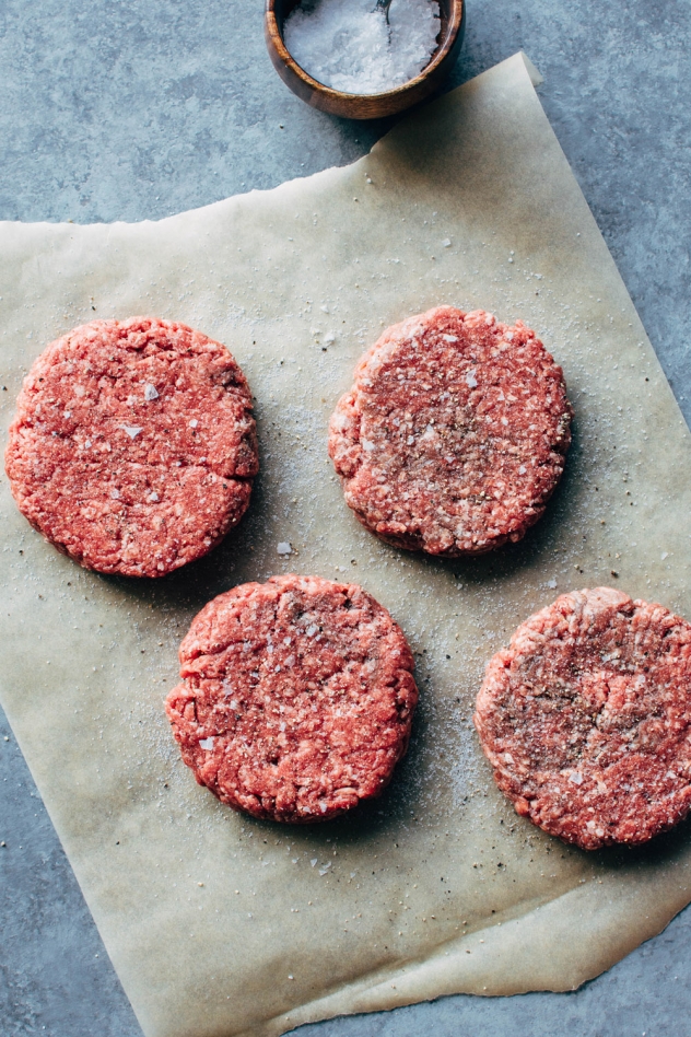 Raw beef patties seasoned with salt and pepper for the ultimate bunless burger.