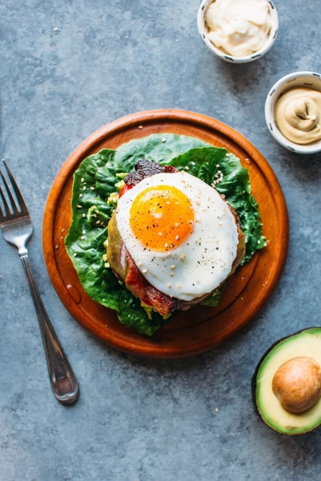 Overhead shot of the ultimate bunless burger topped with a sunny side up fried egg.