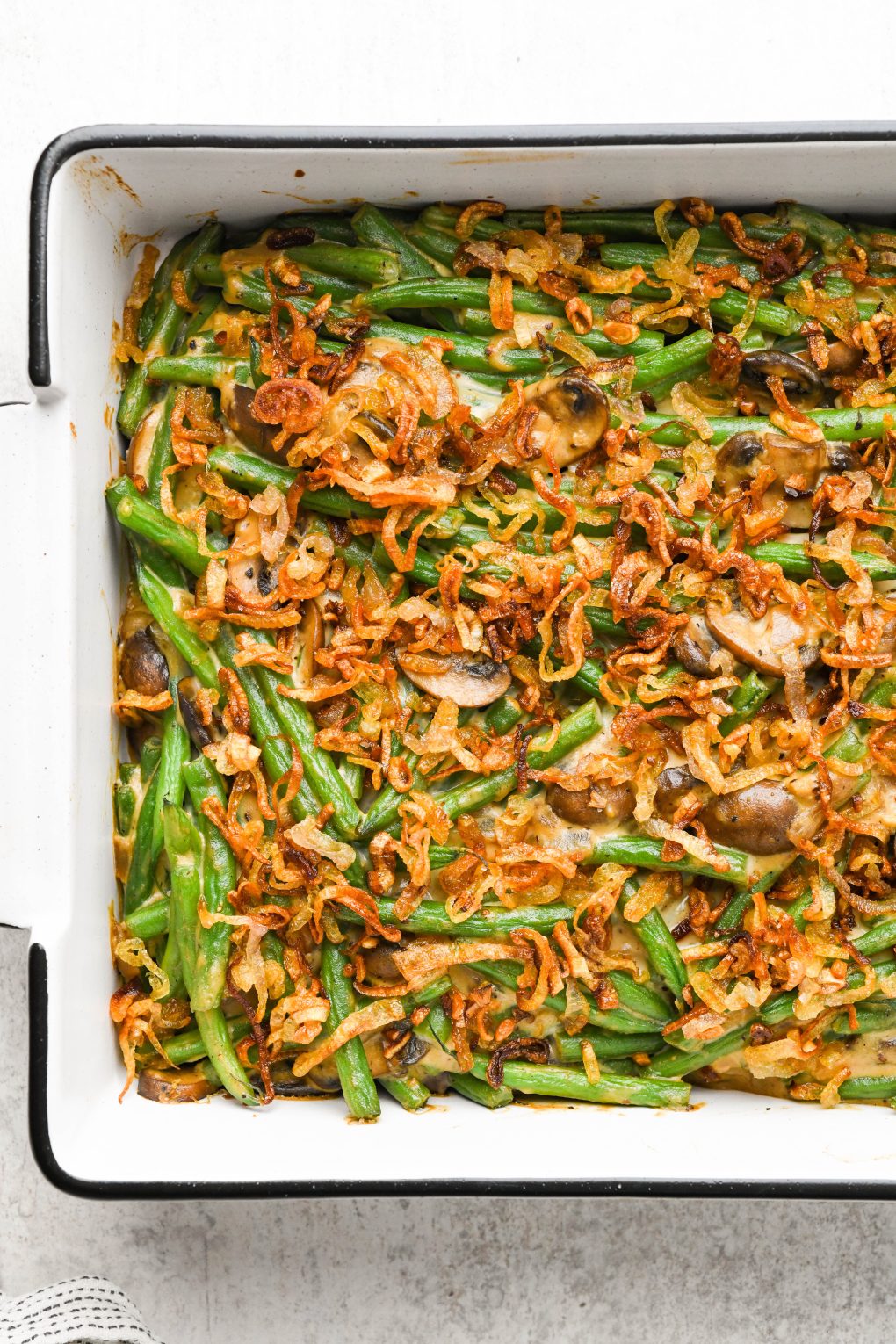 Baked gluten free green bean casserole topped with crispy shallots. 