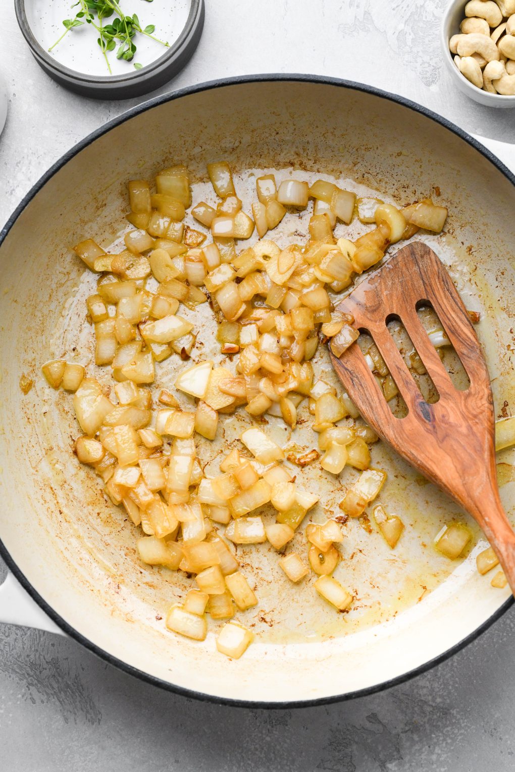 Photos showing how to make Whole30 gravy - diced onions caramelizing in a skillet.