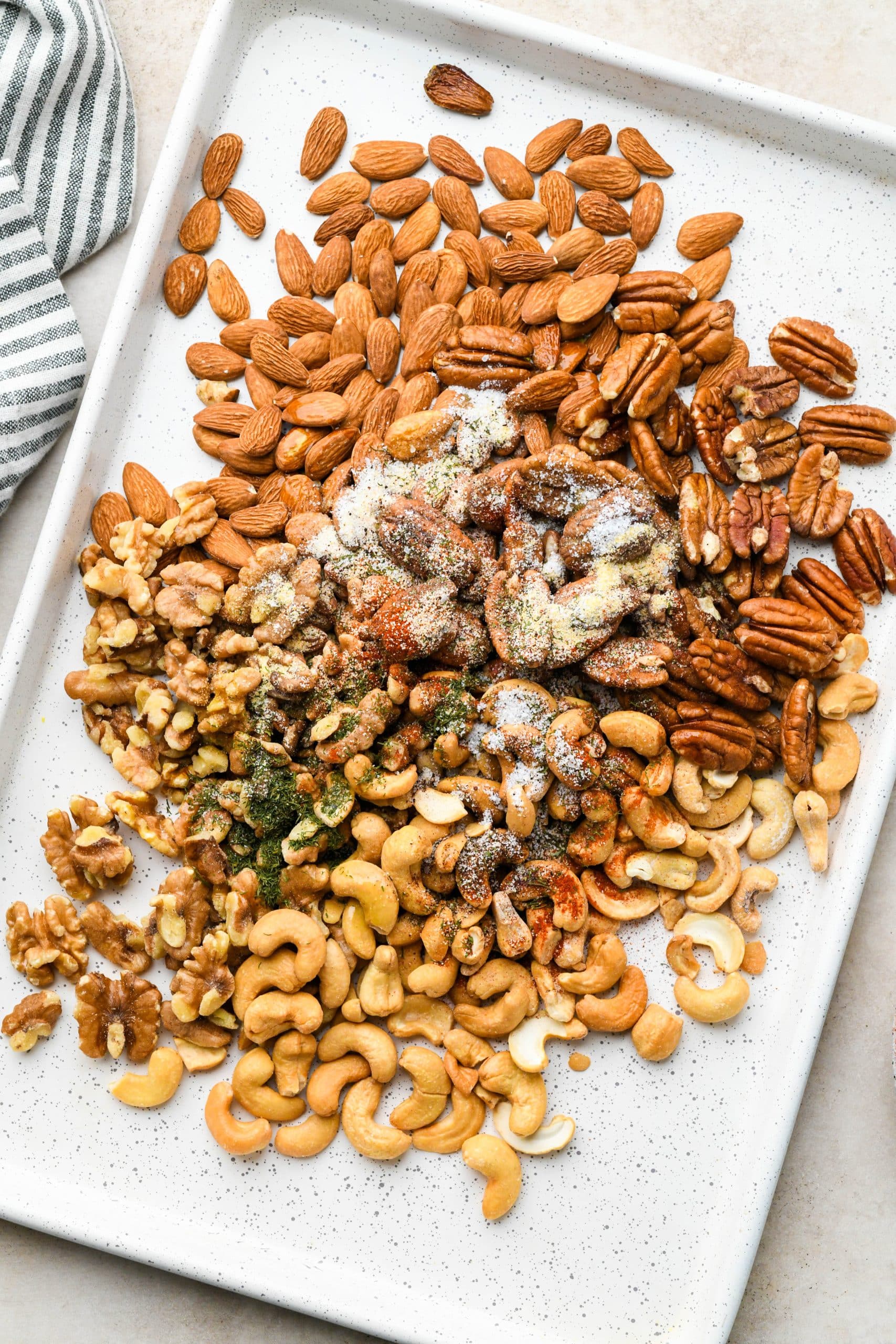 How to make Spiced Roasted Nuts: Mixed nuts topped with olive oil and dried spices.