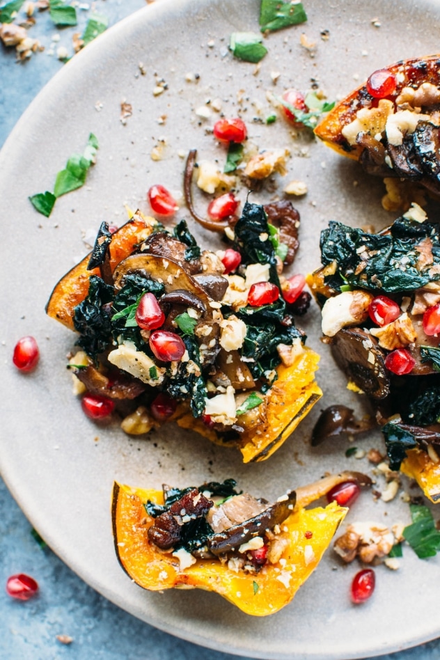 Roasted delicata squash stuffed with kale and maple cinnamon roasted mushrooms is literally bursting with brilliant seasonal flavor and color!