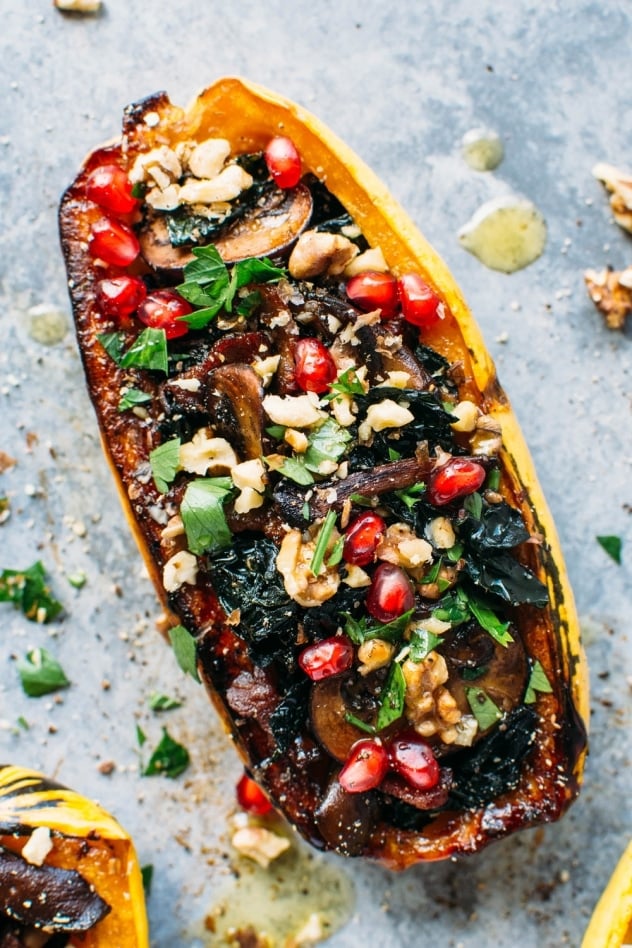 Roasted delicata squash stuffed with kale and maple cinnamon roasted mushrooms is literally bursting with brilliant seasonal flavor and color!