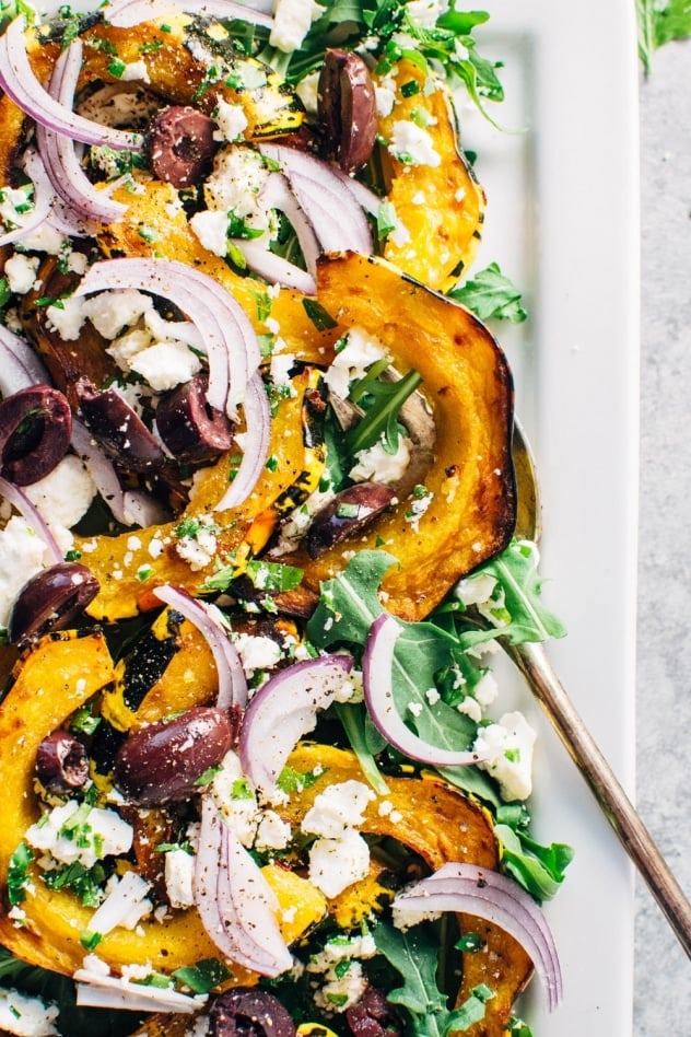 This roasted squash and arugula greek salad is made with maple chili roasted winter squash, peppery arugula and is loaded up with fresh herbs, kalamata olives, red onion and feta cheese. So much flavor and veggies make this a winning flavor bomb of a salad! 