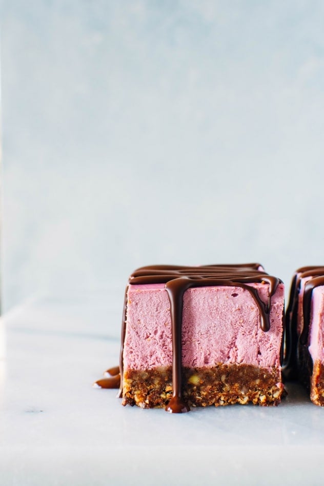 These Raspberry Chocolate No Bake Superfood Cheesecake Bars with Rawmio Chocolate are dairy free, gluten free, and refined sugar free! They're also loaded up with superfoods, healthy fats and fresh fruit! Crave worthy and good for you, they're perfect for anyone you wanna show some love on Valentine's day, or any other day of the year! 