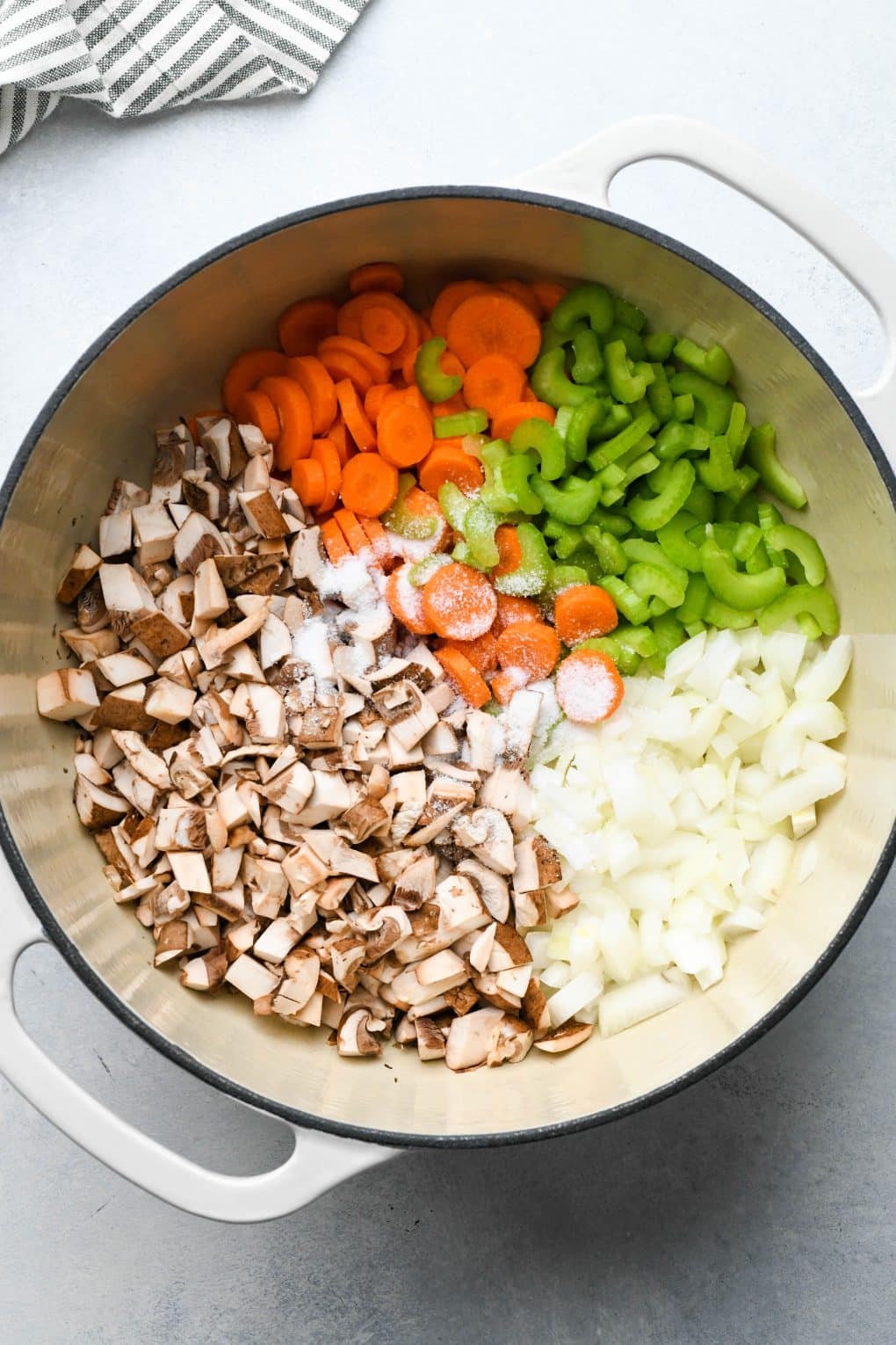 How to make Creamy Dairy Free Chicken and Cauliflower Rice Soup: Raw aromatics and veggies in soup pot with olive oil.