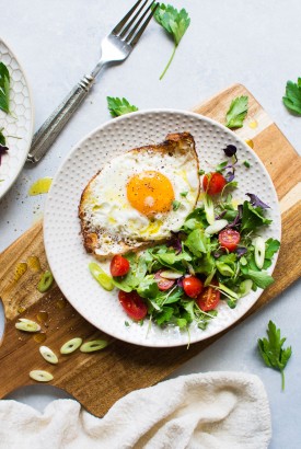 These olive oil fried eggs with a fresh herb and tomato salad are made with only a few ingredients and are legit a delightful dream of a real food breakfast! Or lunch, or dinner, if you're the kind of person who could eat fried eggs for every meal #totallyme.