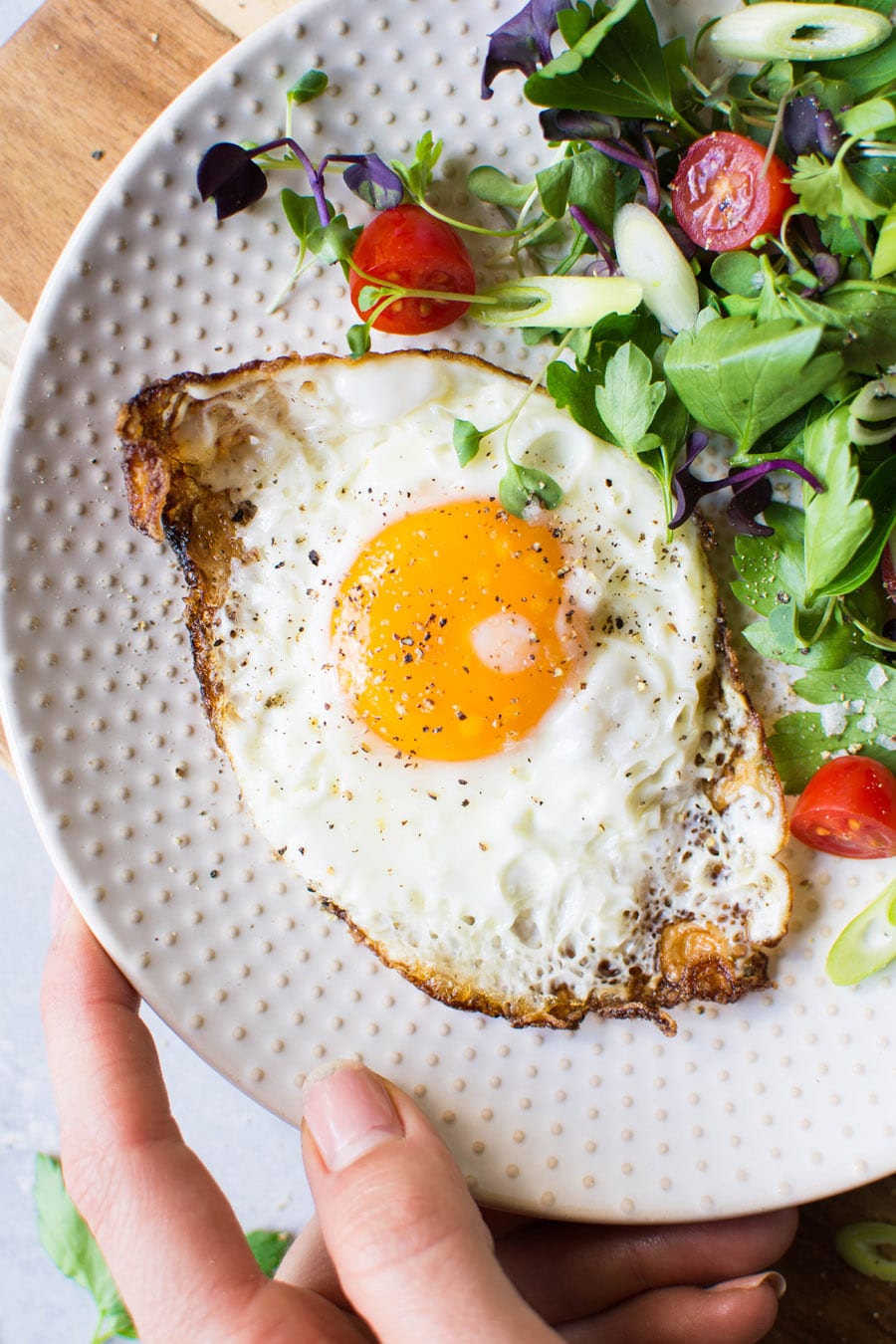 olive-oil-fried-eggs-with-a-fresh-herb-and-tomato-salad-paleo