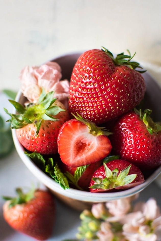 This naturally sweetened strawberry mint shrub is made with juicy seasonal strawberries, fresh mint, white balsamic vinegar, and honey! It's a brilliant bright and tart base for refreshing drinks that you'll enjoy all summer long.