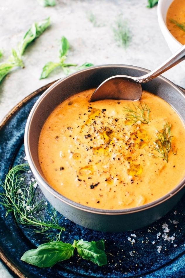 Creamy dairy free tomato and red pepper soup is naturally gluten and dairy free and bursting with summertime flavor. If there’s one soup that fits in this time of year, this tomato soup is it. Made with fresh tomatoes, sweet red pepper, lots of aromatics and soaked cashews for that ultra creamy vibe. A super healthy and comforting version of a summertime classic.