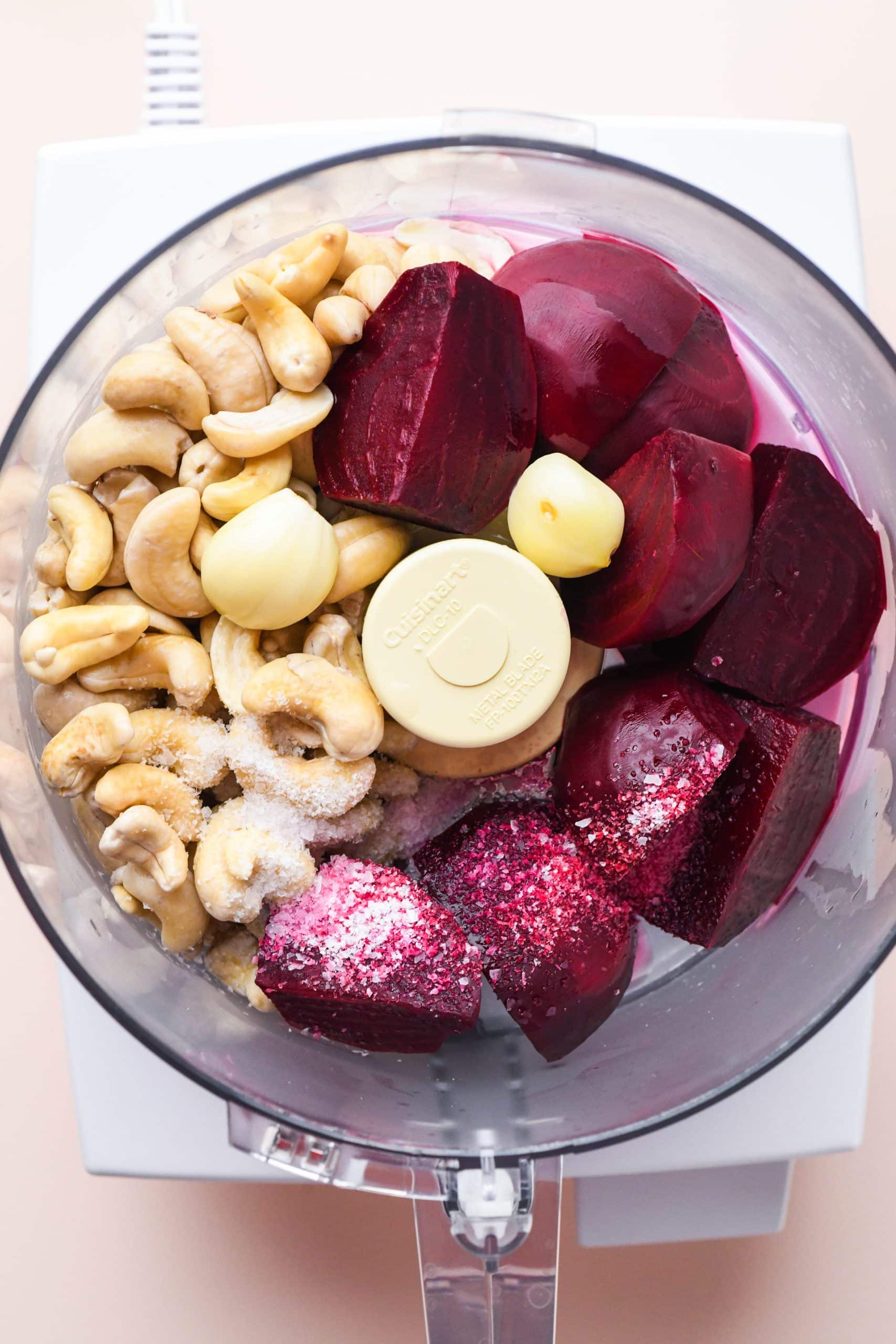 How to make cashew beet dip: Ingredients for dip in the bowl of a food processor.