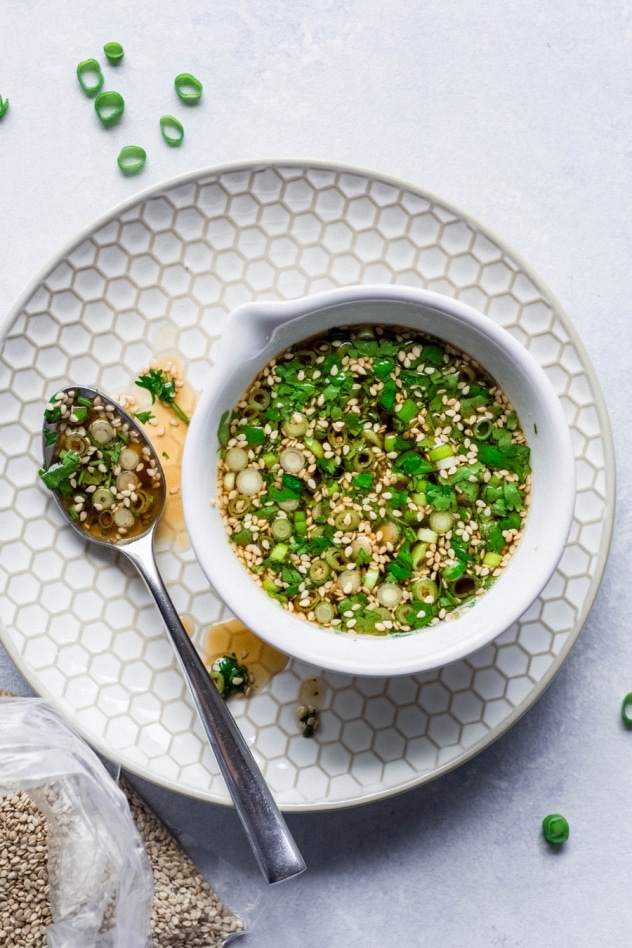 This 5 minute paleo green onion cilantro sauce is MAGIC, you guys. One of those sauces that you can make a million times and eat with every type of meal - from roasted veggies to a cast iron steak to buckwheat noodles. Ready in a flash and made with minimal ingredients, it will take an any meal from good to amazing!