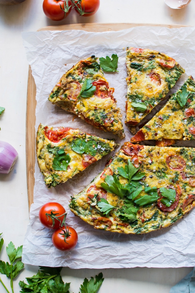 This late summer frittata with tomatoes and fresh herbs has been my go-to egg dish pretty much since it's been warm enough to wear sandals! Made with good-for-you pasture raised eggs, ripe summer tomatoes, savory caramelized shallots, spinach, and fresh parsley for some seriously delicious flavor - it's a must try!